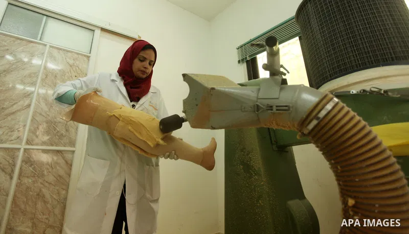 Lana Al-Kronz, 26-year-old Palestinian specialist of prosthetic works on an artificial leg at a center of prosthetic limbs, in Gaza City on April 21, 2015. Al-Krunz is the first Palestinian woman which makes the prosthet...