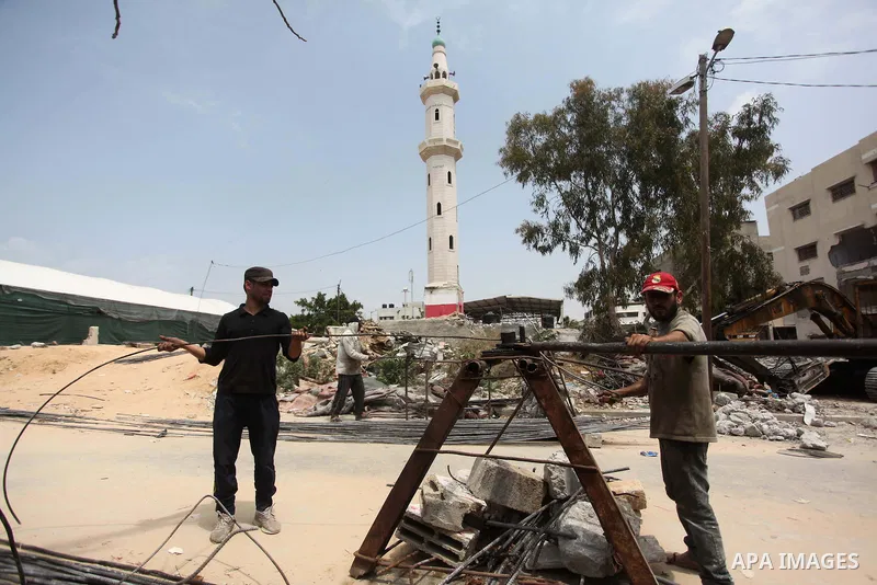 Palestinian workers mend iron bars collected from the rubbles of houses, that witnesses said were destroyed by Israeli shelling during the 50-day Israeli war in the summer of 2014, in Gaza city on April 22, 2015. Accordi...