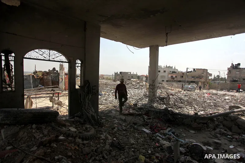 A Palestinian worker collects iron bars from the rubbles of houses, that witnesses said were destroyed by Israeli shelling during the 50-day Israeli war in the summer of 2014, in the eastern Gaza City neighborhood of She...