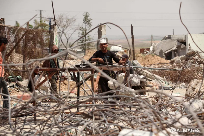 Palestinian workers mend iron bars collected from the rubbles of houses, that witnesses said were destroyed by Israeli shelling during the 50-day Israeli war in the summer of 2014, in the eastern Gaza City neighborhood o...