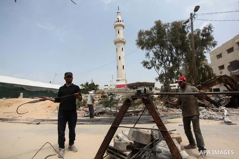 Palestinian workers mend iron bars collected from the rubbles of houses, that witnesses said were destroyed by Israeli shelling during the 50-day Israeli war in the summer of 2014, in Gaza city on April 22, 2015. Accordi...