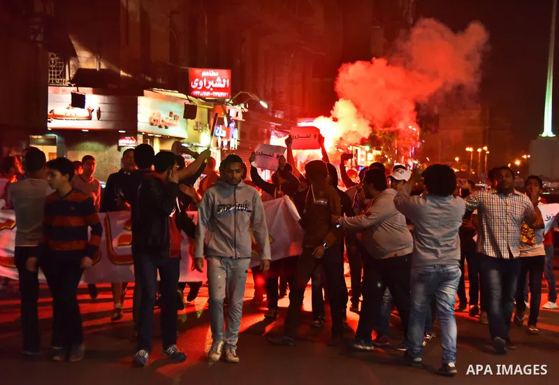 Members of Ultras Nahdawy groupe, who are supporters of the Muslim Brotherhood and ousted President Mohamed Morsi, light flares and shout slogans during a demonstration against the military and interior ministry at Tahri...