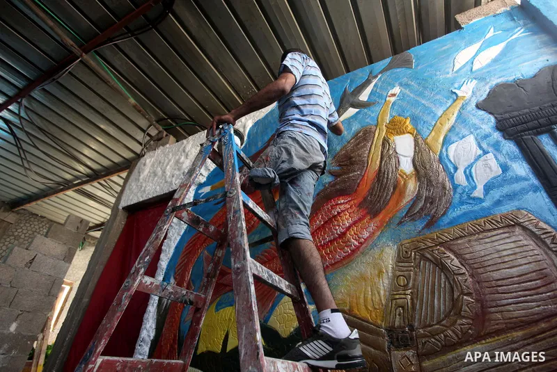 Palestinian artist Jihad Al-Ghoul, 23, works at his house in Bureij refugee camp in the center Gaza Strip, on April 25, 2015. Al-Ghoul said that he lost his leg in an Israeli attacked on Bureij refugee camp in 2008. Phot...