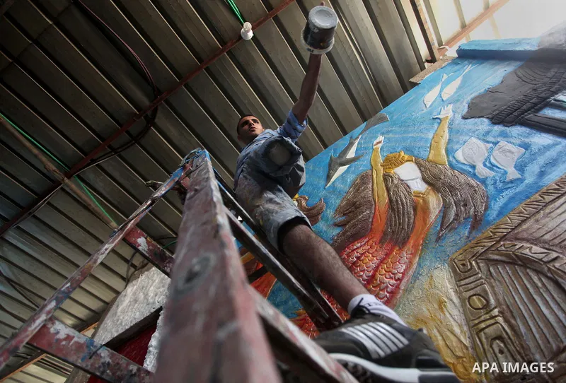 Palestinian artist Jihad Al-Ghoul, 23, works at his house in Bureij refugee camp in the center Gaza Strip, on April 25, 2015. Al-Ghoul said that he lost his leg in an Israeli attacked on Bureij refugee camp in 2008. Phot...