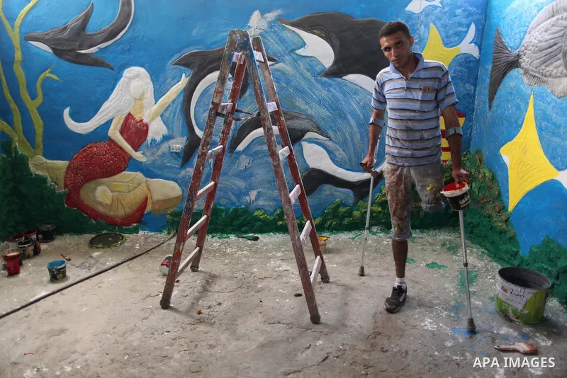 Palestinian artist Jihad Al-Ghoul, 23, works at his house in Bureij refugee camp in the center Gaza Strip, on April 25, 2015. Al-Ghoul said that he lost his leg in an Israeli attacked on Bureij refugee camp in 2008. Phot...
