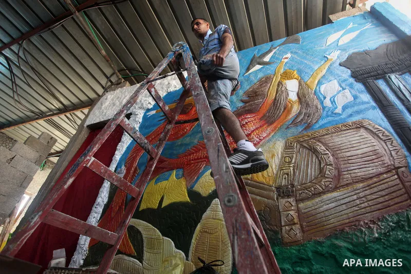 Palestinian artist Jihad Al-Ghoul, 23, works at his house in Bureij refugee camp in the center Gaza Strip, on April 25, 2015. Al-Ghoul said that he lost his leg in an Israeli attacked on Bureij refugee camp in 2008. Phot...