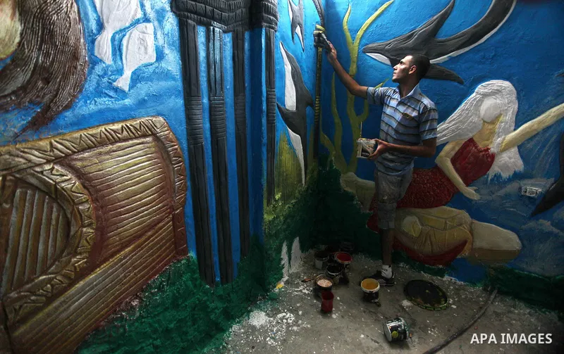 Palestinian artist Jihad Al-Ghoul, 23, works at his house in Bureij refugee camp in the center Gaza Strip, on April 25, 2015. Al-Ghoul said that he lost his leg in an Israeli attacked on Bureij refugee camp in 2008. Phot...