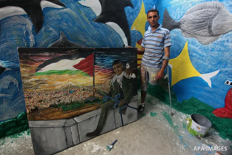 Palestinian artist Jihad Al-Ghoul, 23, works at his house in Bureij refugee camp in the center Gaza Strip, on April 25, 2015. Al-Ghoul said that he lost his leg in an Israeli attacked on Bureij refugee camp in 2008. Phot...