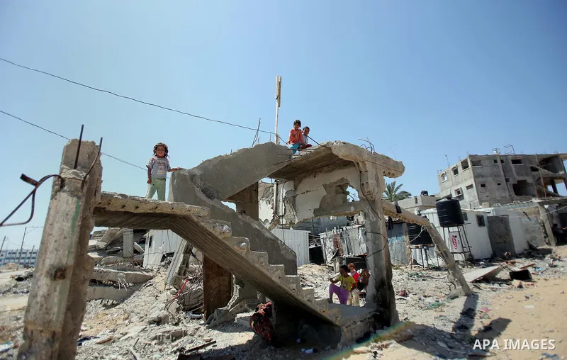 Palestinian children play on the rubble of their family house which destroyed during the 50-day war between Israel and Hamas militants in the summer of 2014, in Beit Lahiya in the northern Gaza Strip on April 26, 2015. P...