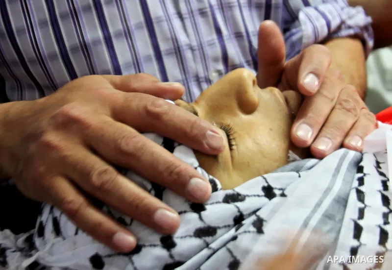 Palestinian relatives of Muhammad Yahiya, 18, gather around his body at a morgue of the Rafidia Governmental Hospital in the West Bank city of April 28, 2015. Yahiya died from injuries sustained during clashes with Israe...