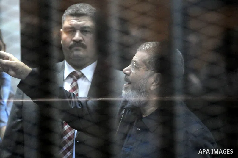 Egyptian President, Mohammad Morsi, stands behind bars as his trial on charges of espionage continues, Cairo, Egypt, 28 April 2015. Morsi has been charged along with several others of leaking classified documents while P...