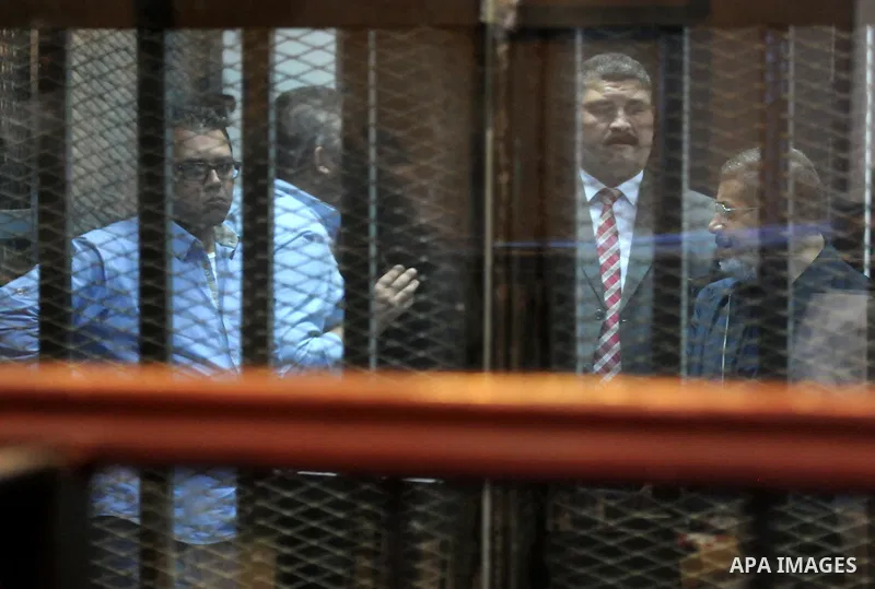Egyptian President, Mohammad Morsi, stands behind bars as his trial on charges of espionage continues, Cairo, Egypt, 28 April 2015. Morsi has been charged along with several others of leaking classified documents while P...