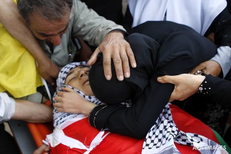 Relatives mourn over the body of Palestinian Mohammad Saleh, 18, during his funeral in the West Bank village of Alaraqa near Jenin April 28, 2015. Saleh shot by Israeli soldiers in the occupied West Bank died of his woun...