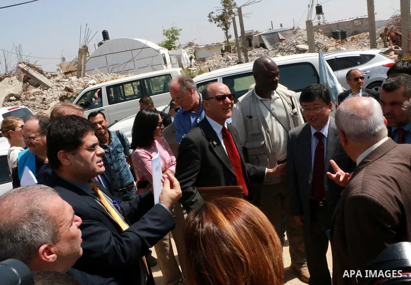 James Rawley, United Nations' humanitarian coordinator for the Palestinian territories, visits the temporary homes of Palestinian who lost their houses during the 50-day Israeli war in the summer of 2014, east of Khan Yo...