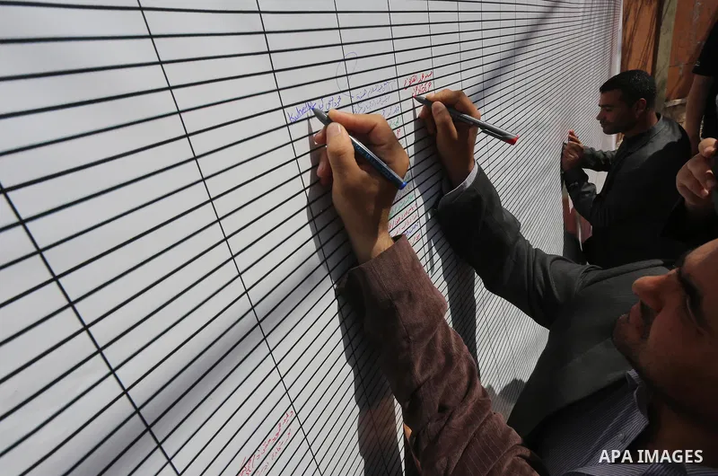 Palestinians sign a symbolic document against Israel's settlements and separation barrier in the Palestinian Authority-controlled West Bank, on April 29, 2015 in Gaza City. Photo by Mohammed Asad