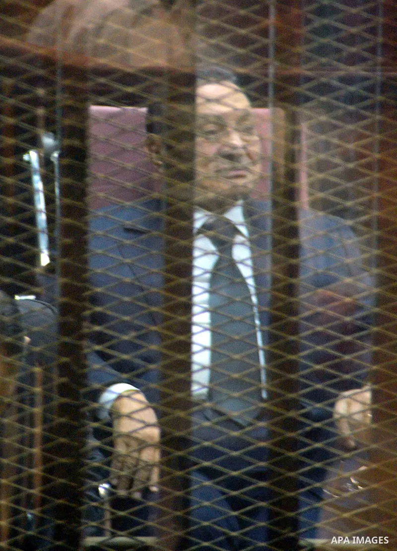 Former Egyptian President Hosni Mubarak sits behind bars in a defendants' cage at a courtroom during his trial in Cairo, Egypt, 29 April 2015. Mubarak appeared in the retrial session on charges of fraudulently spending m...