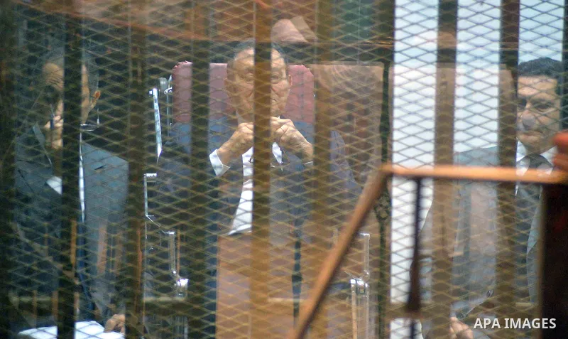 Former Egyptian President Hosni Mubarak sits behind bars in a defendants' cage at a courtroom during his trial in Cairo, Egypt, 29 April 2015. Mubarak appeared in the retrial session on charges of fraudulently spending m...
