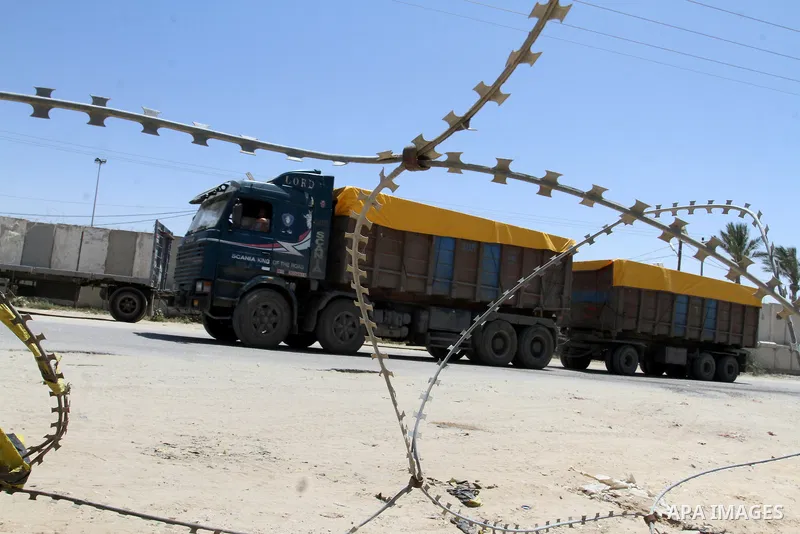 A truck carrying building materials is seen after it entered the southern Gaza Strip from Israel through the Kerem Shalom crossing in Rafah on April 29, 2015. Photo by Abed Rahim Khatib