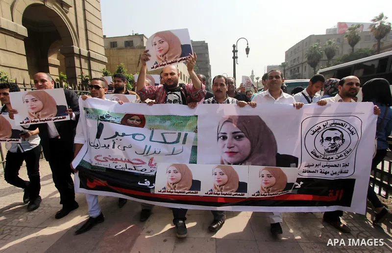 Egyptian Journalists hold pictures of thier fellow Mayada Ashraf, who was killed by Egyptian police,during a protest in Cairo on April 29, 2015. Photo by Amr Sayed