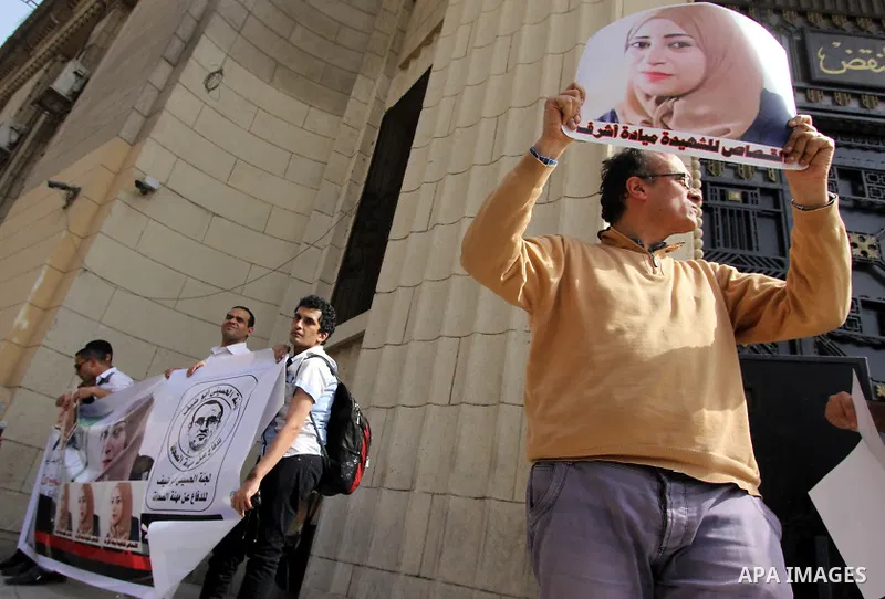 Egyptian Journalists hold pictures of thier fellow Mayada Ashraf, who was killed by Egyptian police, in front of the Cassation court, in Cairo on April 29, 2015. Photo by Amr Sayed