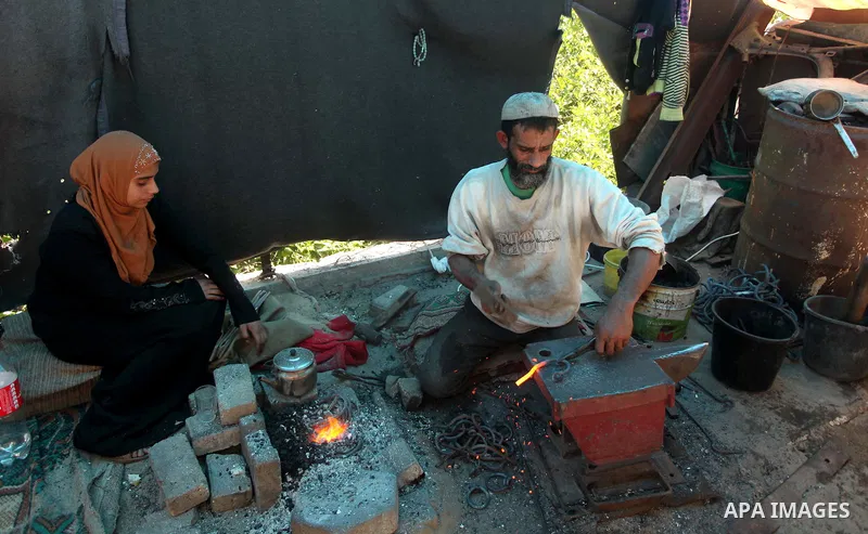 Palestinian blacksmith Ibraheem Mustafa, 40-year-old, hammers heated steel, at his small workshop in Gaza city on April 30, 2015. The ILO estimates that the 2014 conflict in Gaza raised unemployment from 32.6 per cent to...