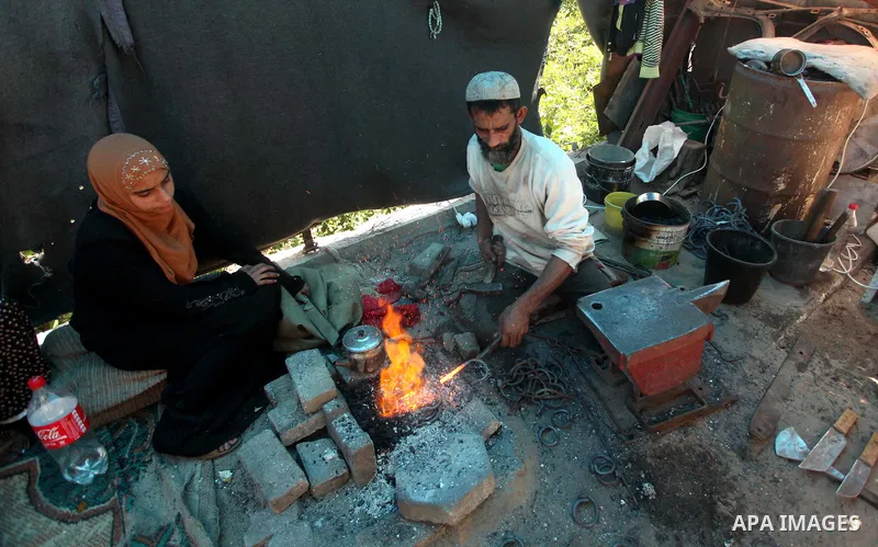 Palestinian blacksmith Ibraheem Mustafa, 40-year-old, hammers heated steel, at his small workshop in Gaza city on April 30, 2015. The ILO estimates that the 2014 conflict in Gaza raised unemployment from 32.6 per cent to...