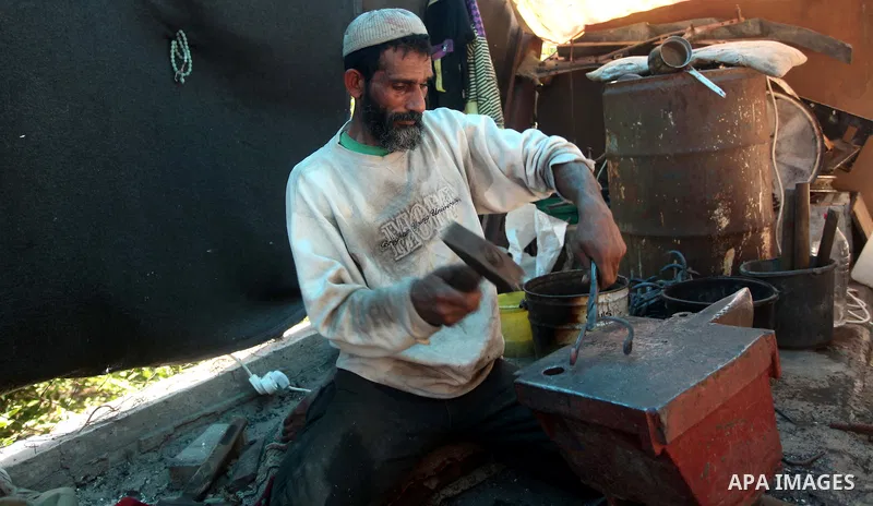 Palestinian blacksmith Ibraheem Mustafa, 40-year-old, hammers heated steel, at his small workshop in Gaza city on April 30, 2015. The ILO estimates that the 2014 conflict in Gaza raised unemployment from 32.6 per cent to...