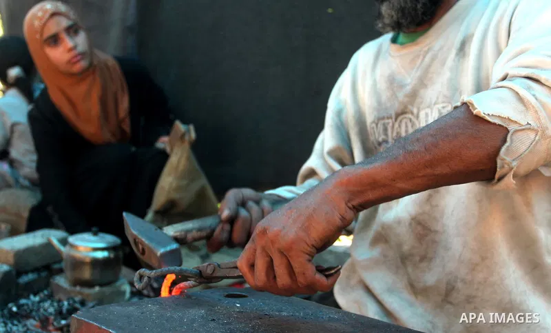 Palestinian blacksmith Ibraheem Mustafa, 40-year-old, hammers heated steel, at his small workshop in Gaza city on April 30, 2015. The ILO estimates that the 2014 conflict in Gaza raised unemployment from 32.6 per cent to...