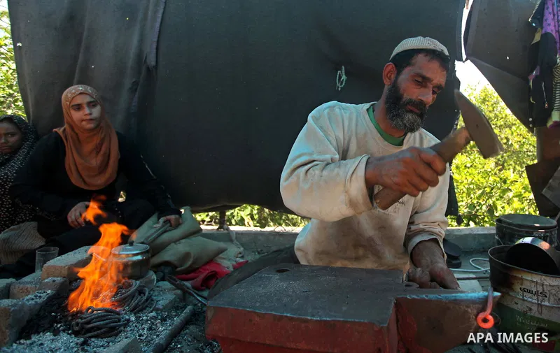 Palestinian blacksmith Ibraheem Mustafa, 40-year-old, hammers heated steel, at his small workshop in Gaza city on April 30, 2015. The ILO estimates that the 2014 conflict in Gaza raised unemployment from 32.6 per cent to...