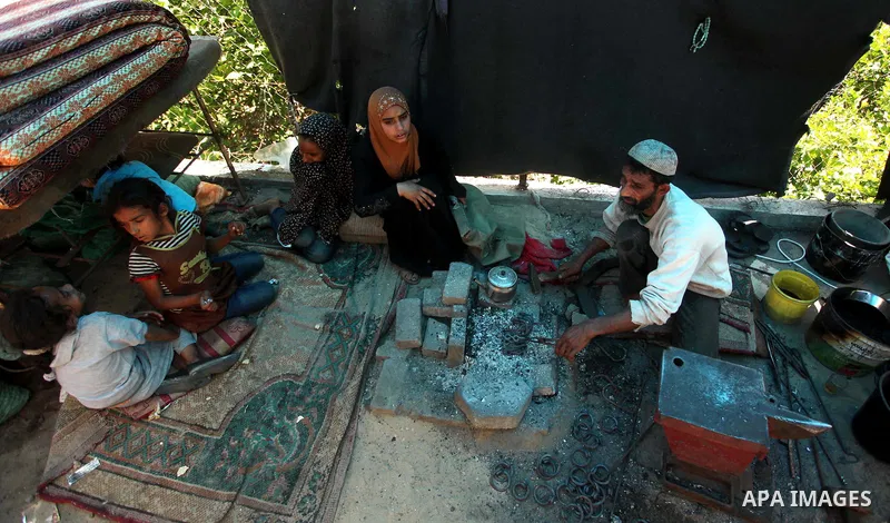 Palestinian blacksmith Ibraheem Mustafa, 40-year-old, melts a steel bar, at his small workshop in Gaza city on April 30, 2015. The ILO estimates that the 2014 conflict in Gaza raised unemployment from 32.6 per cent to 36...