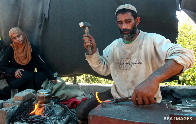 Palestinian blacksmith Ibraheem Mustafa, 40-year-old, hammers heated steel, at his small workshop in Gaza city on April 30, 2015. The ILO estimates that the 2014 conflict in Gaza raised unemployment from 32.6 per cent to...