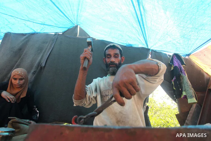 Palestinian blacksmith Ibraheem Mustafa, 40-year-old, hammers heated steel, at his small workshop in Gaza city on April 30, 2015. The ILO estimates that the 2014 conflict in Gaza raised unemployment from 32.6 per cent to...