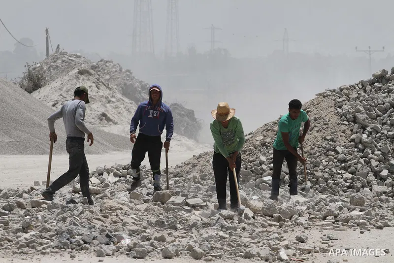 Palestinian workers crush stones and cement blocks from houses destroyed by Israeli shelling during the 50-day Israeli war in the summer of 2014, in the eastern Gaza City neighborhood of Shejaiya on April 30, 2015. The I...