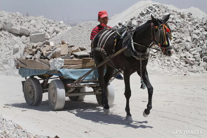 Palestinian workers crush stones and cement blocks from houses destroyed by Israeli shelling during the 50-day Israeli war in the summer of 2014, in the eastern Gaza City neighborhood of Shejaiya on April 30, 2015. The I...