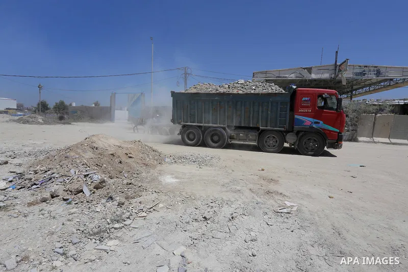 Palestinian workers crush stones and cement blocks from houses destroyed by Israeli shelling during the 50-day Israeli war in the summer of 2014, in the eastern Gaza City neighborhood of Shejaiya on April 30, 2015. The I...