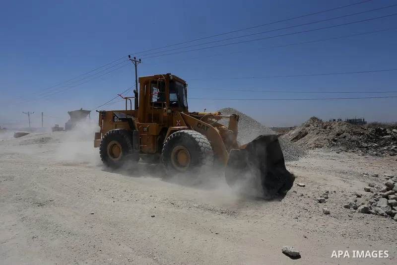Palestinian workers crush stones and cement blocks from houses destroyed by Israeli shelling during the 50-day Israeli war in the summer of 2014, in the eastern Gaza City neighborhood of Shejaiya on April 30, 2015. The I...