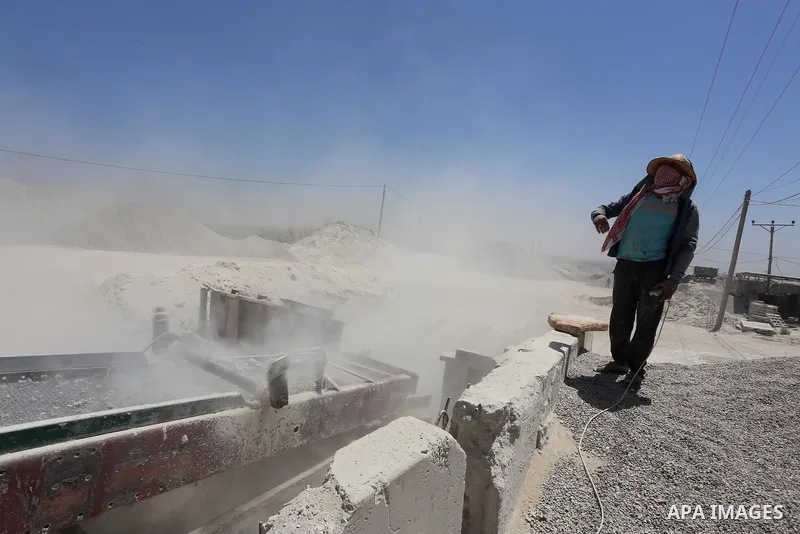 Palestinian workers crush stones and cement blocks from houses destroyed by Israeli shelling during the 50-day Israeli war in the summer of 2014, in the eastern Gaza City neighborhood of Shejaiya on April 30, 2015. The I...