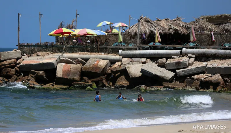 Palestinian children swim at the beach of Gaza city on April 30, 2015. Photo by Ashraf Amra