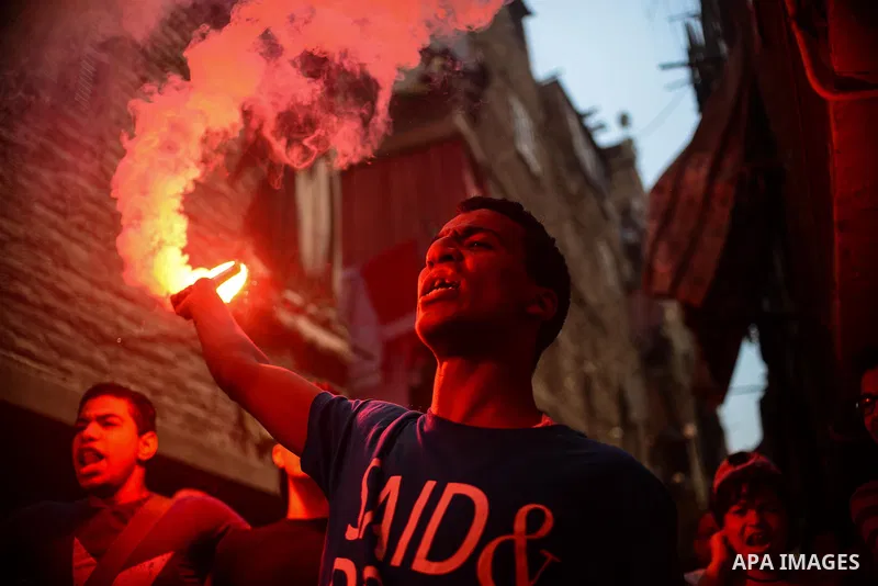 Egyptian supporters of Muslim Brotherhood and ousted president Mohammed Morsi, lights flares during a protest against military rule in al-Matariya district, near Cairo on May 1, 2015. Photo by Amr Sayed