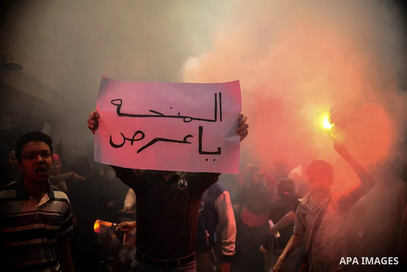 Egyptian supporters of Muslim Brotherhood and ousted president Mohammed Morsi, lights flares during a protest against military rule in al-Matariya district, near Cairo on May 1, 2015. Photo by Amr Sayed