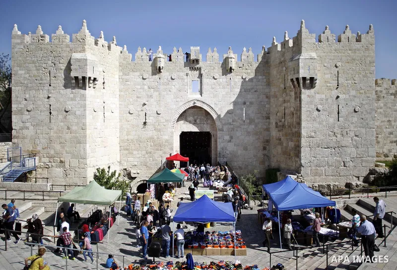 Palestinians walk in front of Damascus gate outside the al-Aqsa mosque compound, in Jerusalem's old city on May 1, 2015. Photo by Saeb Awad