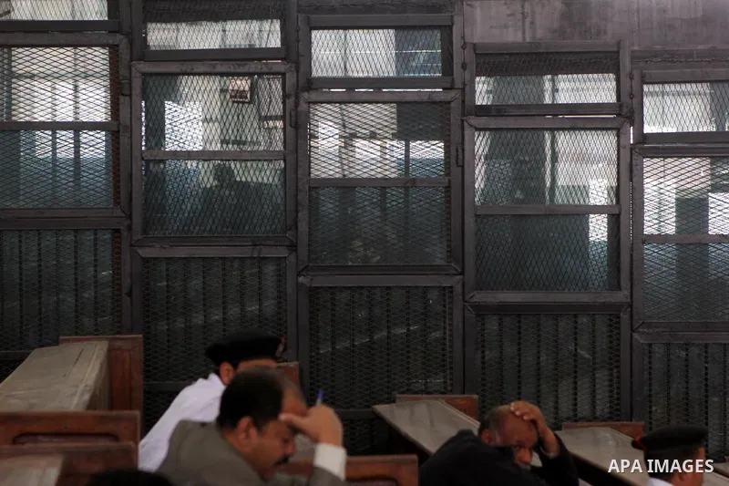 Egyptian Defendants on trial of of Egyptian radical Islamist Mohammed al-Zawahiri, the brother of Al-Qaeda chief Ayman al-Zawahiri sit behind bars as the court in Cairo on May 02, 2015. Photo by Amr Sayed