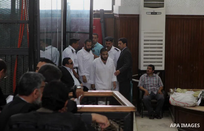 Suspects of of Ansar Bait Al-Maqdis group, attend their trial at a court in Cairo on May 3, 2015. Cairo criminal court Sunday adjourned the trial of 213 suspects of Ansar Bait Al-Maqdis group, on charges of assassination...