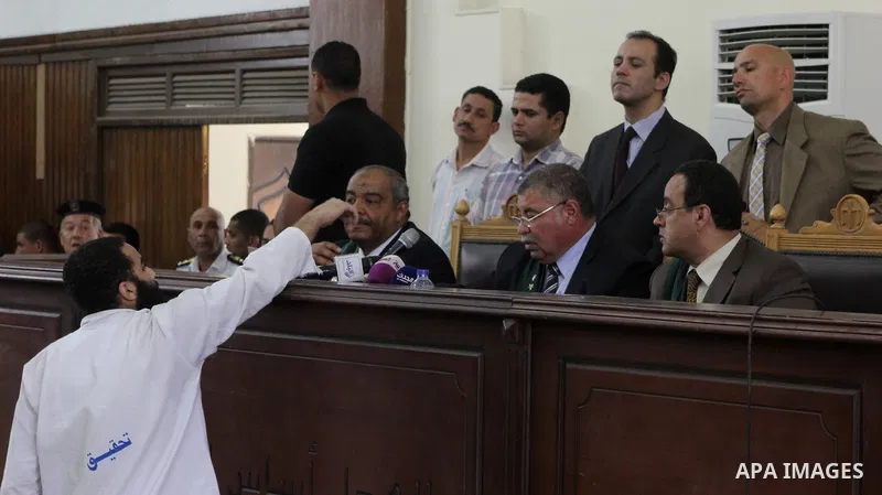A suspect of of Ansar Bait Al-Maqdis group, attends his trial at a court in Cairo on May 3, 2015. Cairo criminal court Sunday adjourned the trial of 213 suspects of Ansar Bait Al-Maqdis group, on charges of assassination...
