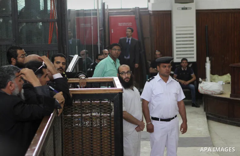 A suspect of of Ansar Bait Al-Maqdis group, attends his trial at a court in Cairo on May 3, 2015. Cairo criminal court Sunday adjourned the trial of 213 suspects of Ansar Bait Al-Maqdis group, on charges of assassination...