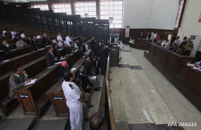 Suspects of of Ansar Bait Al-Maqdis group, stand behind bars in a court room, during their trial in Cairo on May 3, 2015. Cairo criminal court Sunday adjourned the trial of 213 suspects of Ansar Bait Al-Maqdis group, on...