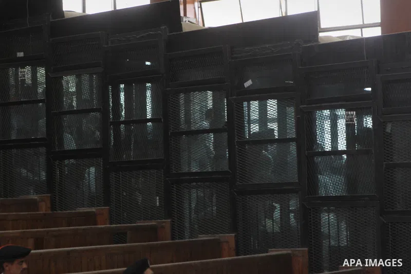 Suspects of of Ansar Bait Al-Maqdis group, stand behind bars in a court room, during their trial in Cairo on May 3, 2015. Cairo criminal court Sunday adjourned the trial of 213 suspects of Ansar Bait Al-Maqdis group, on...