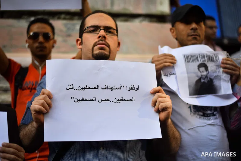 Egyptians hold banners during a rally marking the Journalists Day, outside the journalist syndicate, in Cairo on May 3, 2015. Photo by Amr Sayed