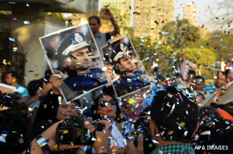 Egyptian supporters of former President Hosni Mubarak hold his picture during a celebration to mark his 87th birthday, outside Maadi military hospital, near Cairo on May 4, 2015. An Egyptian legal authority on Monday rul...
