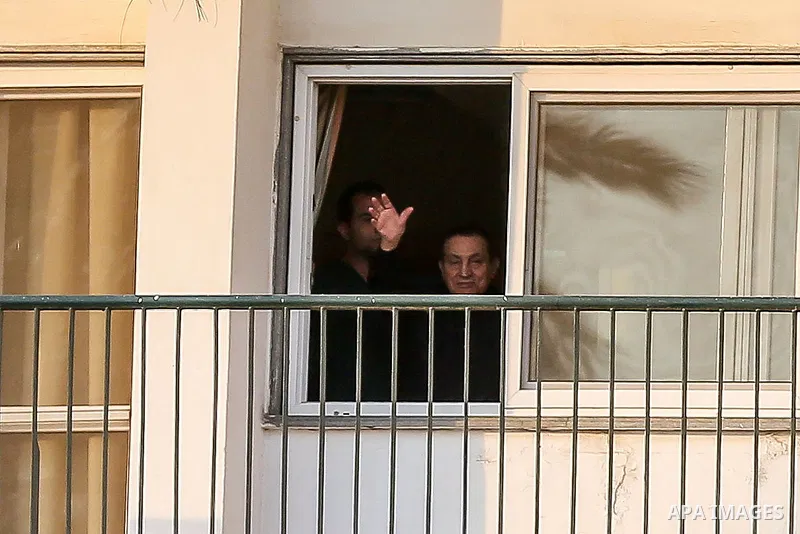 Former Egyptian President Hosni Mubarak waves to supporters during a celebration to mark his 87th birthday, outside Maadi military hospital, near Cairo on May 4, 2015. An Egyptian legal authority on Monday ruled in favor...